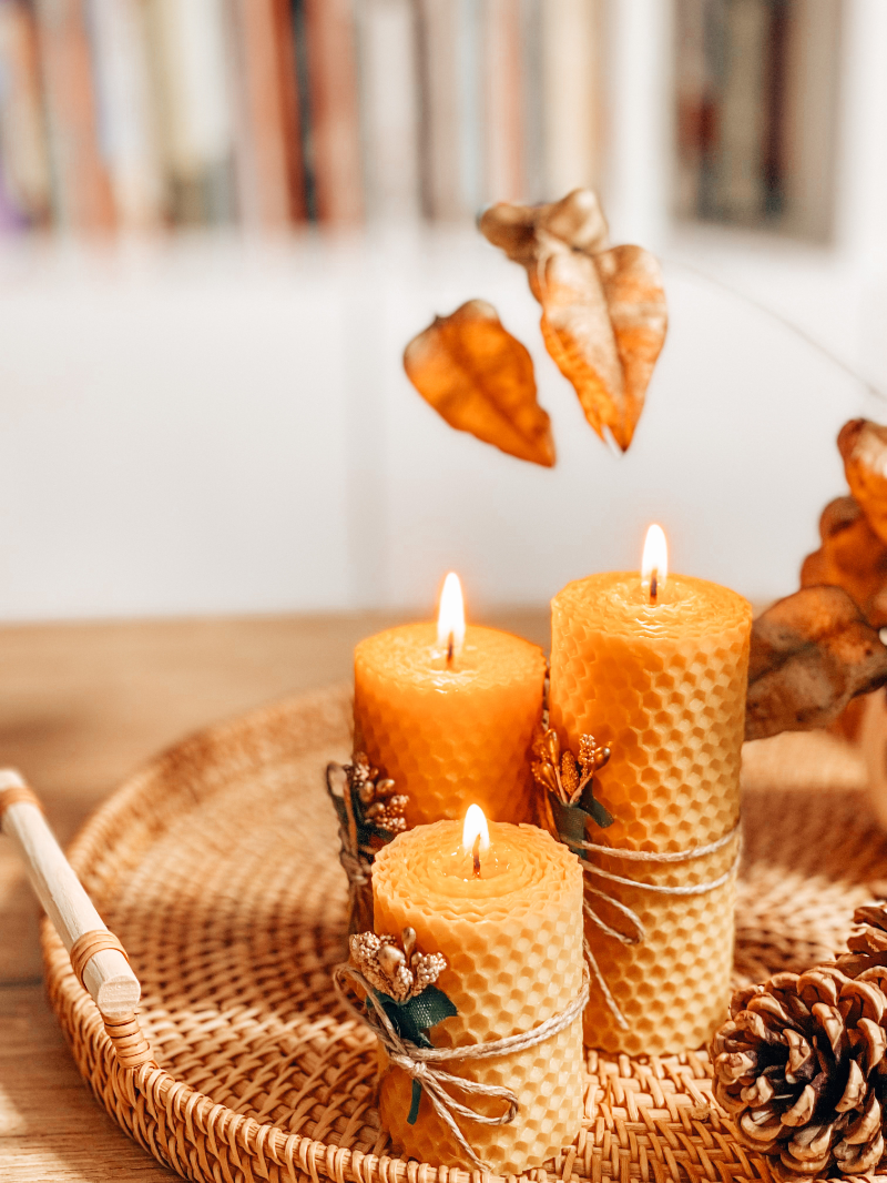 Beeswax candles on a wicker tray