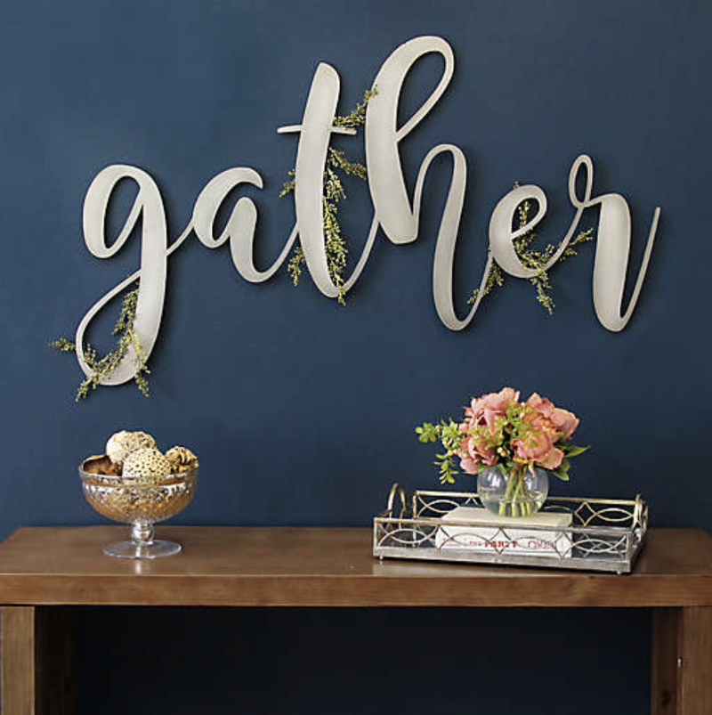 Metal sign depicting the word "gather" in script style